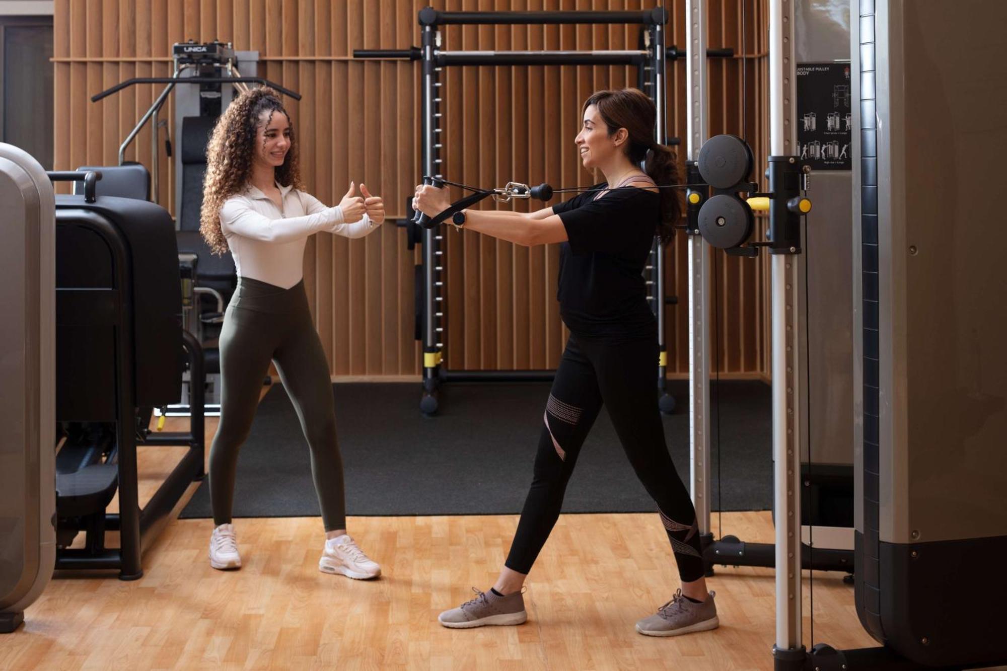 Hyatt Regency Riyadh Olaya Kültér fotó Personal trainer working with a female client